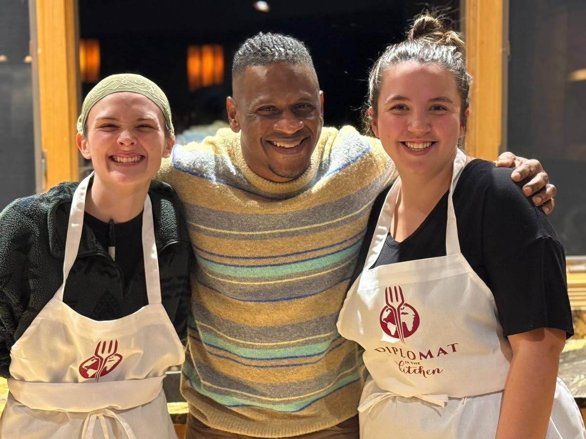 Knight is flanked by culinary arts students, Bee Depuy (left) and Gracie Keller from Missoula during a global culinary adventure in the city, part of a four-city book tour across Montana.