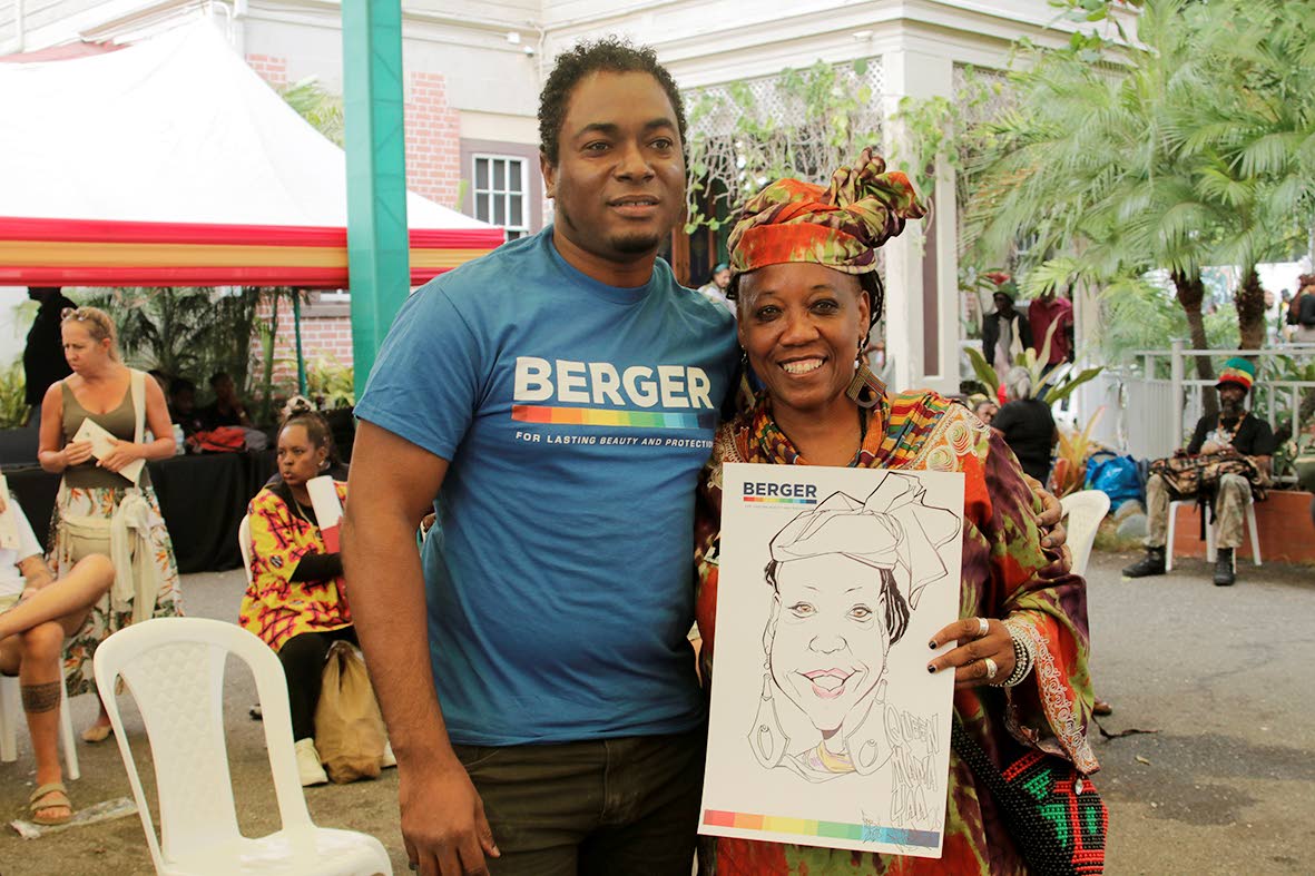 From left: Caricature Artist, Emerald Easy joined Queen Mama Yaa for a snap after completing her drawing on Friday at the Bob Marley Museum.