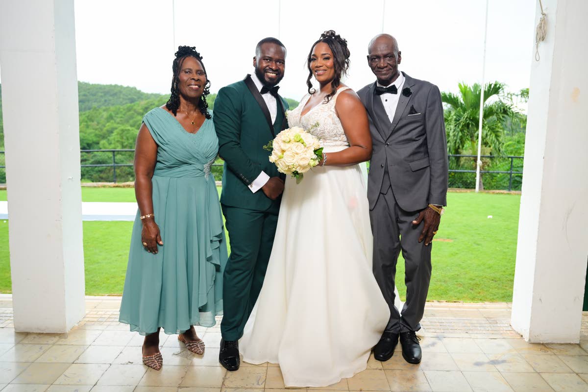 Supporting Mr and Mrs Robotham (centre) are their parents, Estrianna Smith (left), Gareth’s mother, and Austin Spencer (right), Antoinette’s father.