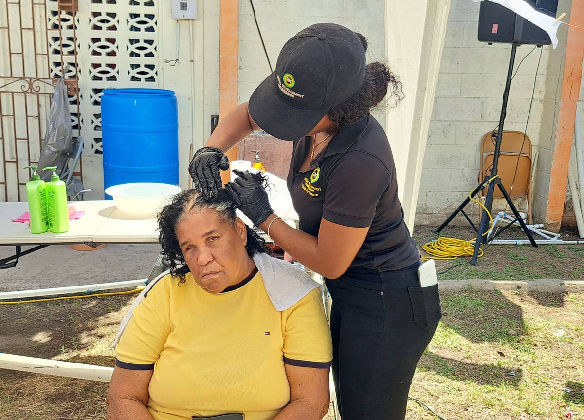 Waterford senior Hyacinth Henry getting her hair done by SDC volunteer Calaya Edwards