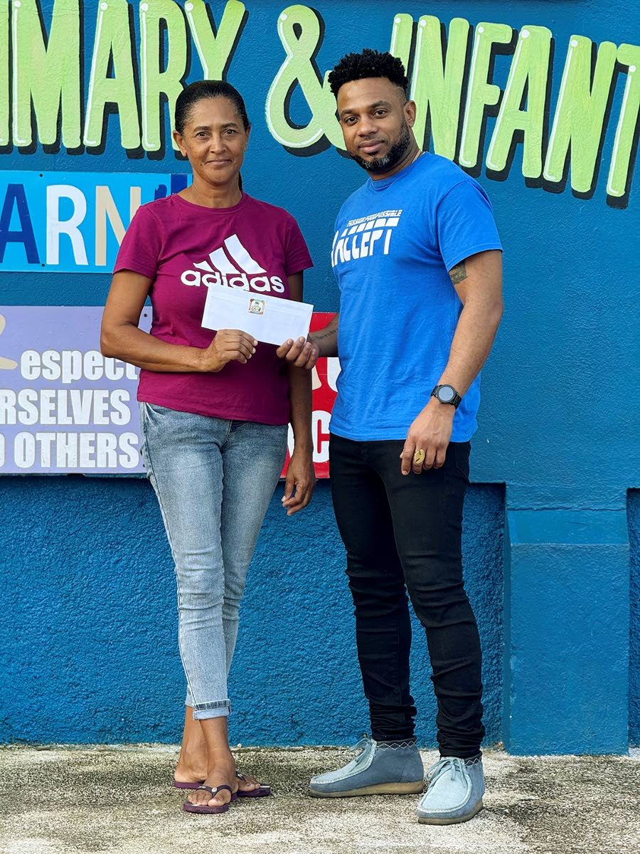 Novlette Moore (left) accepting M:FP C.A.R.E voucher, on behalf of a beneficiary, from Peter Ivey, founder of Mission: FoodPossible