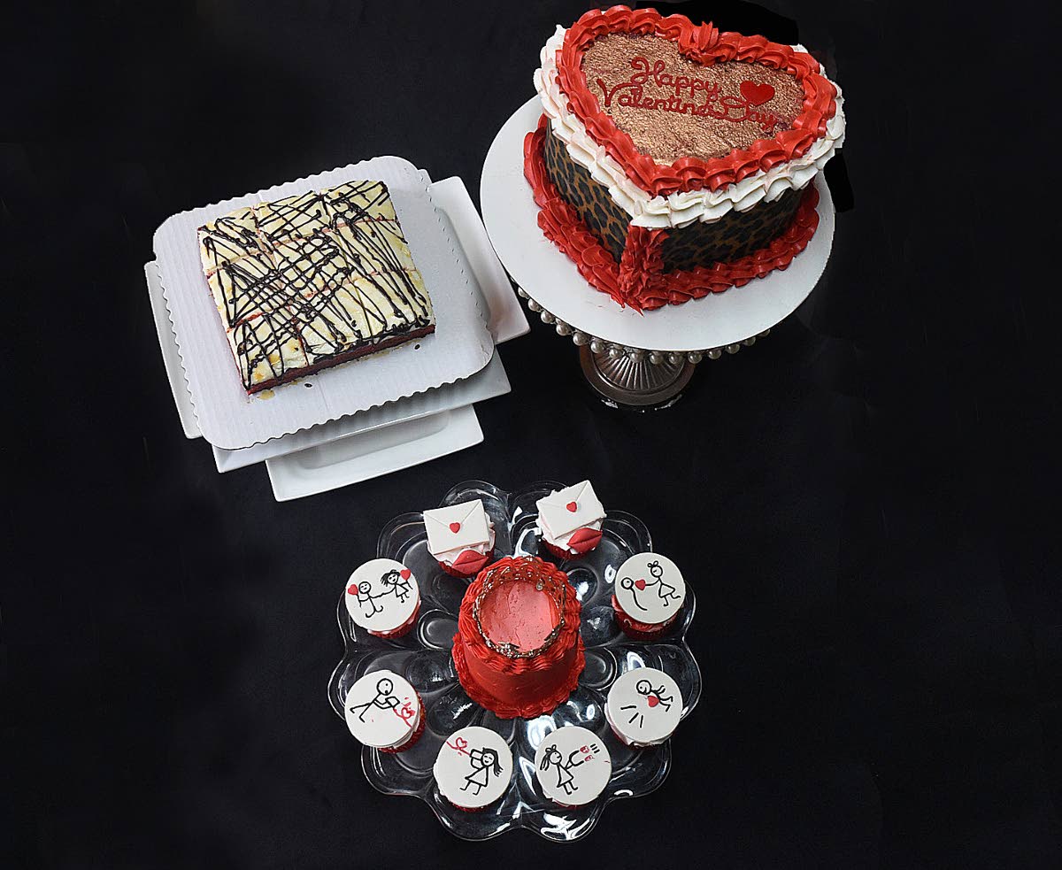 From left: The  Baileys red velvet blondie, a heart-shaped buttercream, vanilla and chocolate cake with a cheetah-print fondant and a Bento box of a crimson icing vanilla cake, encircled by vanilla cupcakes.