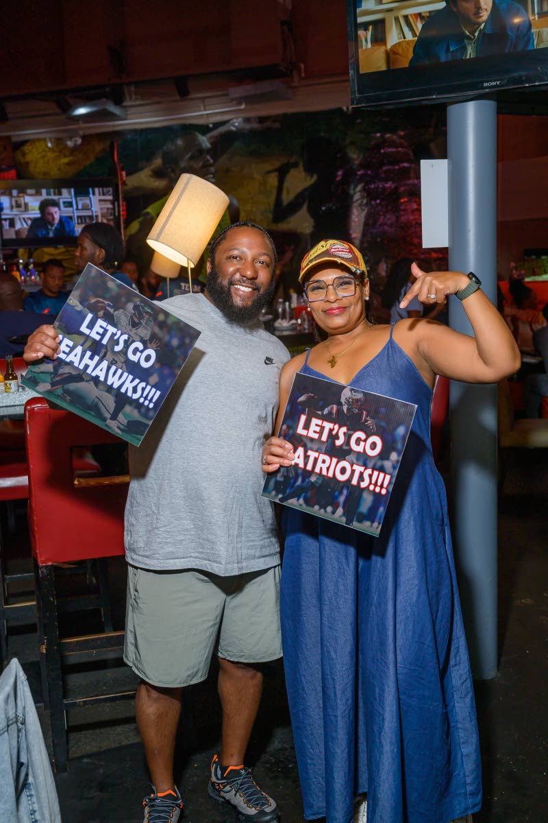 Visiting from the USA, Glen Ross (left) and Nicole Bailey share smiles as the game unfolds.