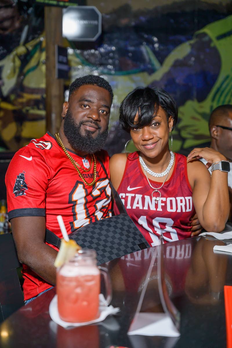 Luther Raphael, CEO of Raphael Financial Ltd , and Shashanna Bernard, NCB Capital Markets senior wealth support officer, pause for a photo amid the 
game-night excitement