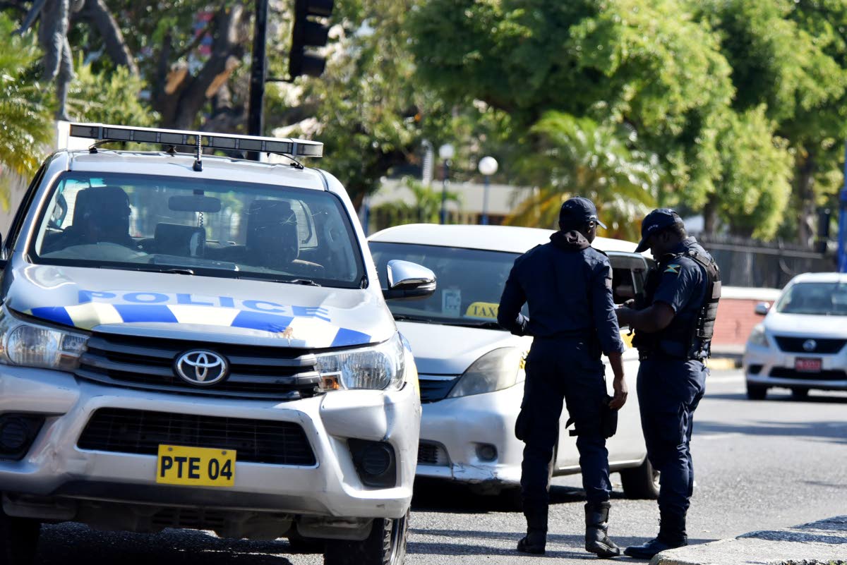 In this file photo JCF personnel are seen checking documents during a spot check.