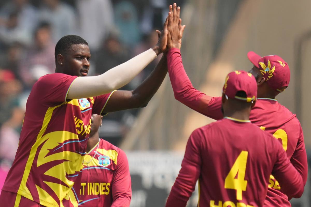 West Indies’ Jason Holder (second left) and Nepal’s Aarif Sheikh during the T20 World Cup cricket match against Nepal in Mumbai, India, on February 15.