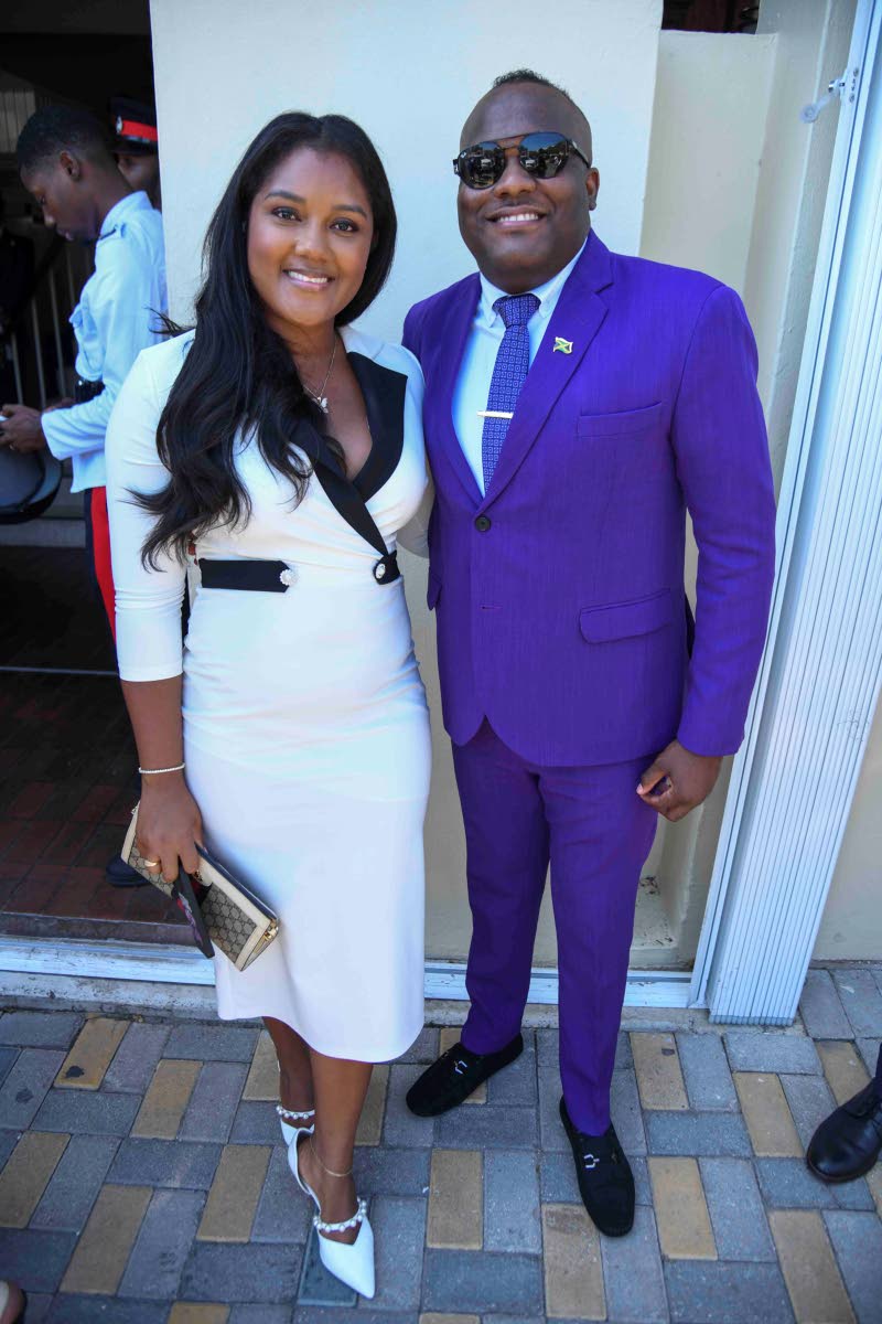 Senator Abka Fitz-Henley dons a purple suit from Spokes Apparel as he pauses for a snap with Nicole Ebanks, advisor in the Ministry of Economic Growth and Job Creation. Ebanks is wearing a black and white tuxedo dress from Ignite Boutique. 