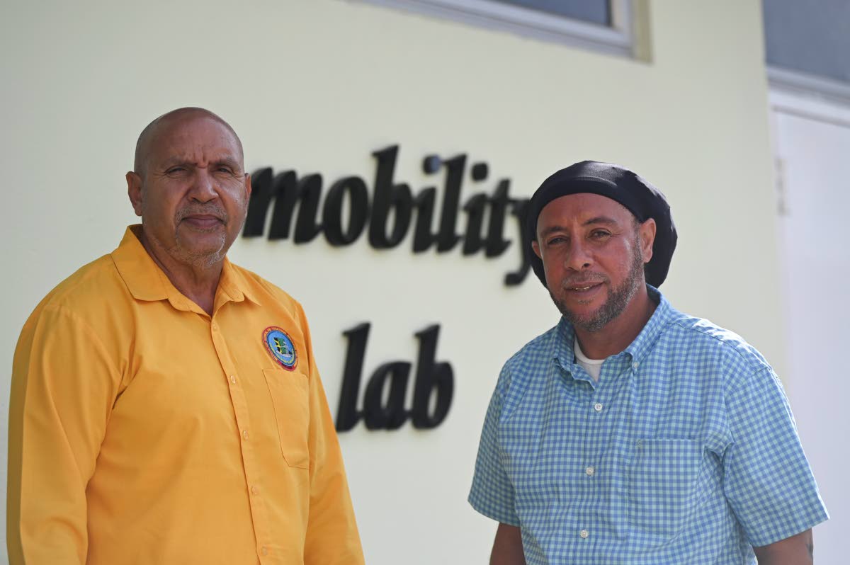 Belizean Eric Vernon (left),  an automotive instructor employed to the Institute for Technical and Vocational Education and Training and Kittian Nicholson Webster, chief foreman mechanic at the Public Works Department in the MInistry of Infrastructure,