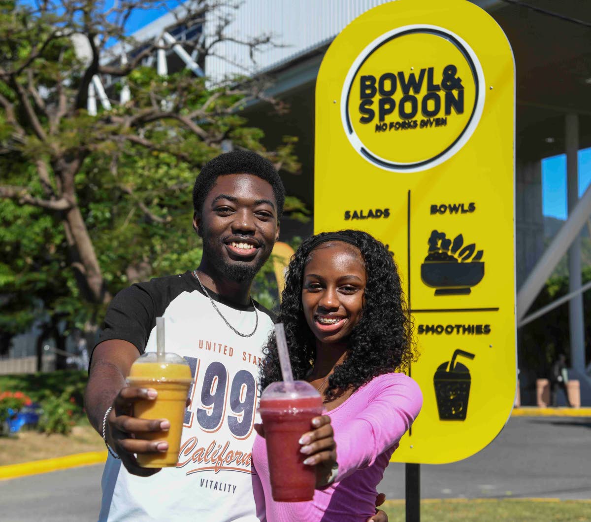 Third-year banking and finance students Amani Christie and Esther-Elizabeth McKenzie enjoy the immunity boost and tropical recharge, respectively, at Bowl and Spoon Restaurant, located at The University of the West Indies (UWI), Mona campus. 