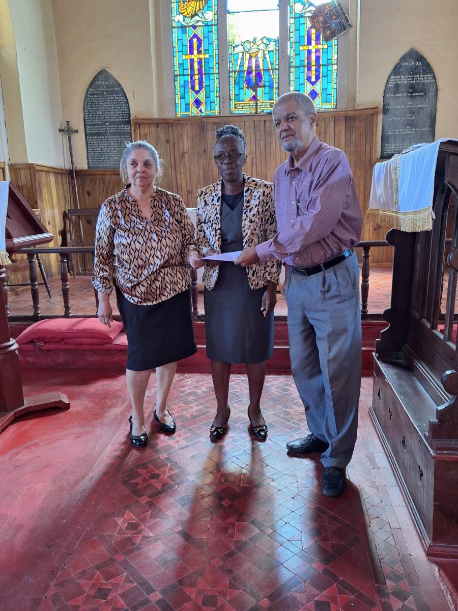 Paul Thorbourne (right) and Cynthia Burton (left), former trustees of the Mavis Fraser-Davis Trust, present a cheque for $1.3 million to Hilary Dennis of St Albans Anglican church in Stanmore district, Malvern, St Elizabeth, on February 1.