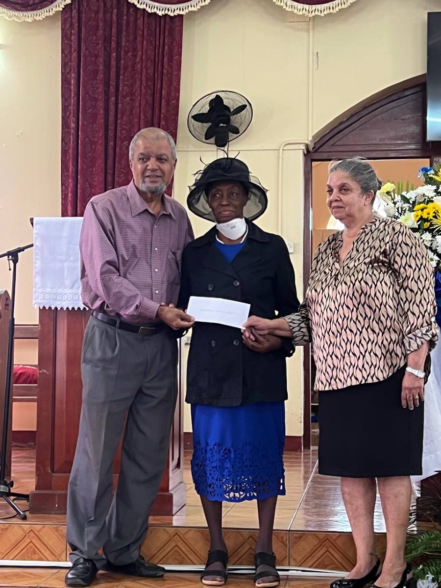 Paul Thorbourne (left) and Cynthia Burton (right), former trustees of the Mavis Fraser-Davis Trust, present a cheque for $1.3 million to Hermina Reid of the Bethlehem Moravian Church in Malvern, St Elizabeth, on February 1.