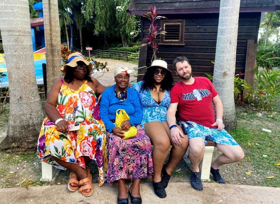 Centenarian Wedie May Howell (second left) surrounded by friends and family.