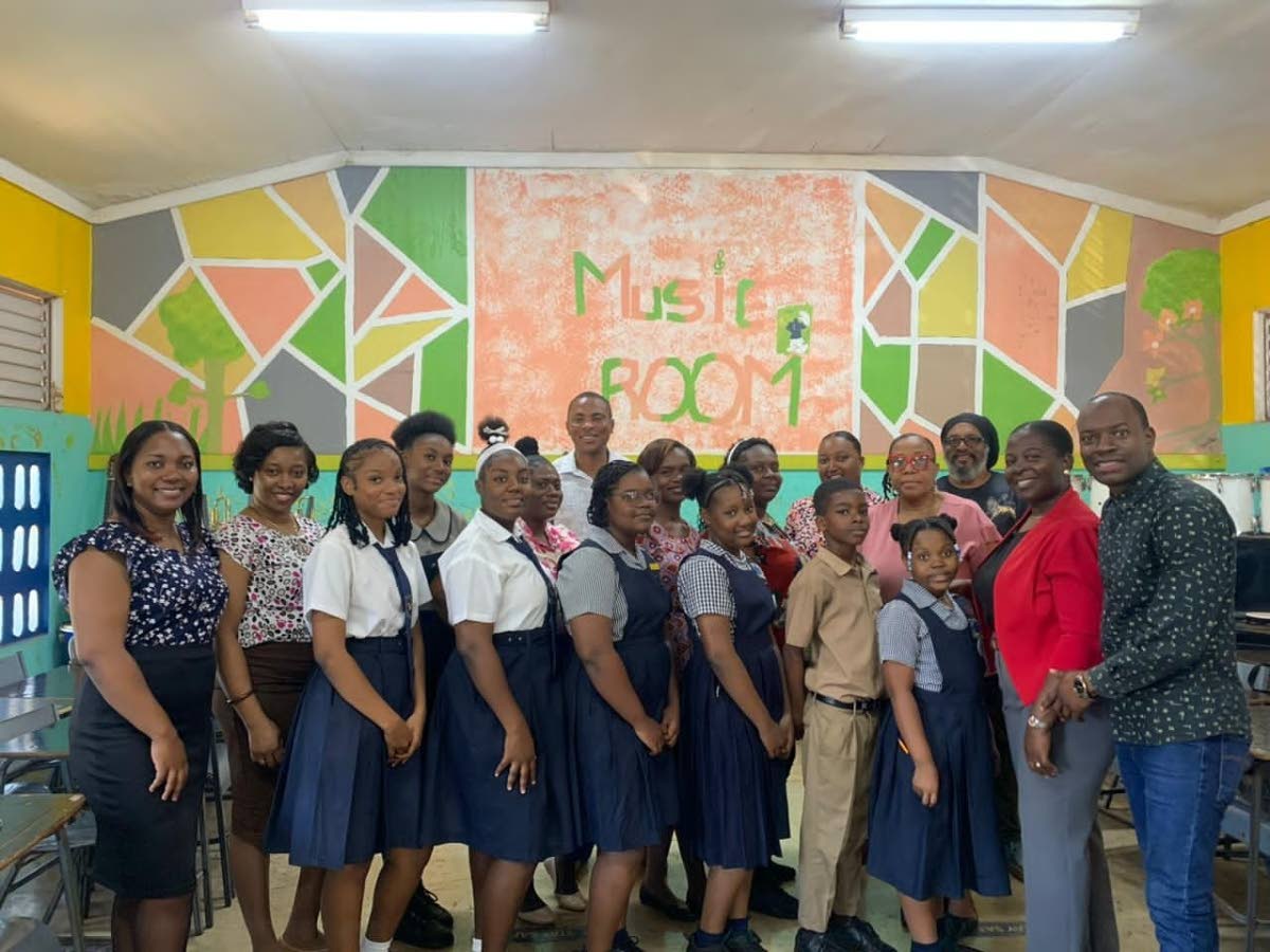 Dalton Wiseman (right), music teacher, poses with students and supporters from New Forest Primary and High schools in Manchester, who came together to create ‘Rebuild Jamaica, an original song inspired by the aftermath of Hurricane Melissa.