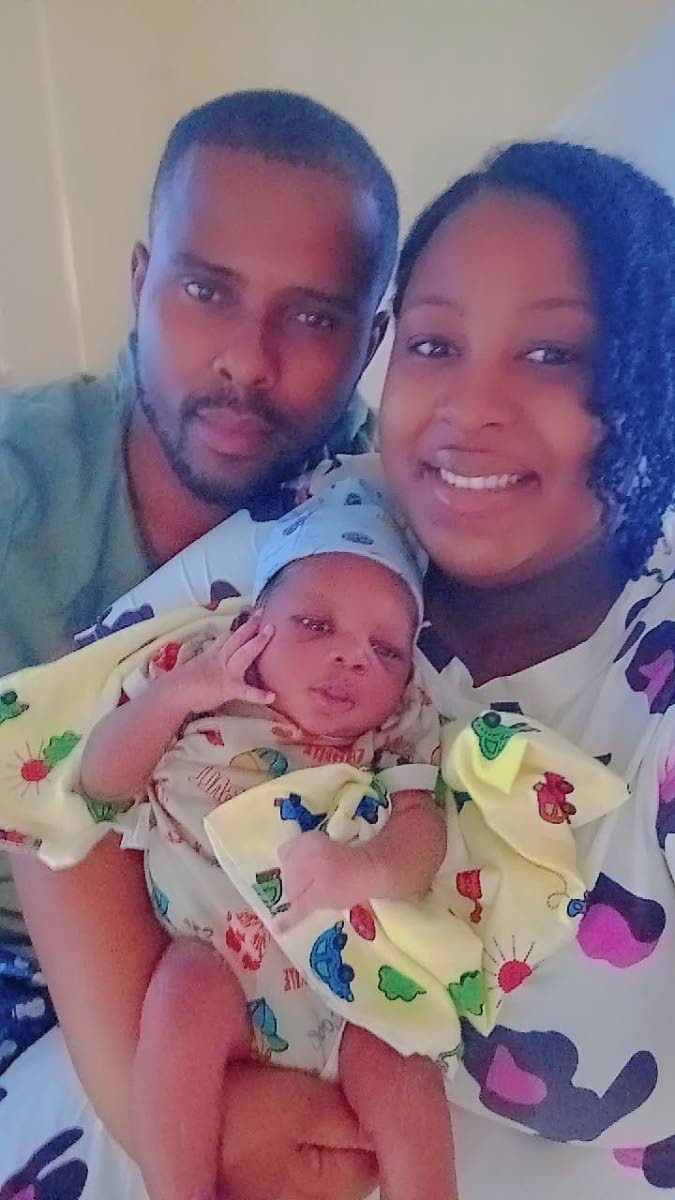 First-time parents, Natasha McKenzie Petgrave and her husband, Jovain Petgrave, cradling their baby boy, who was born on New Year’s Day.