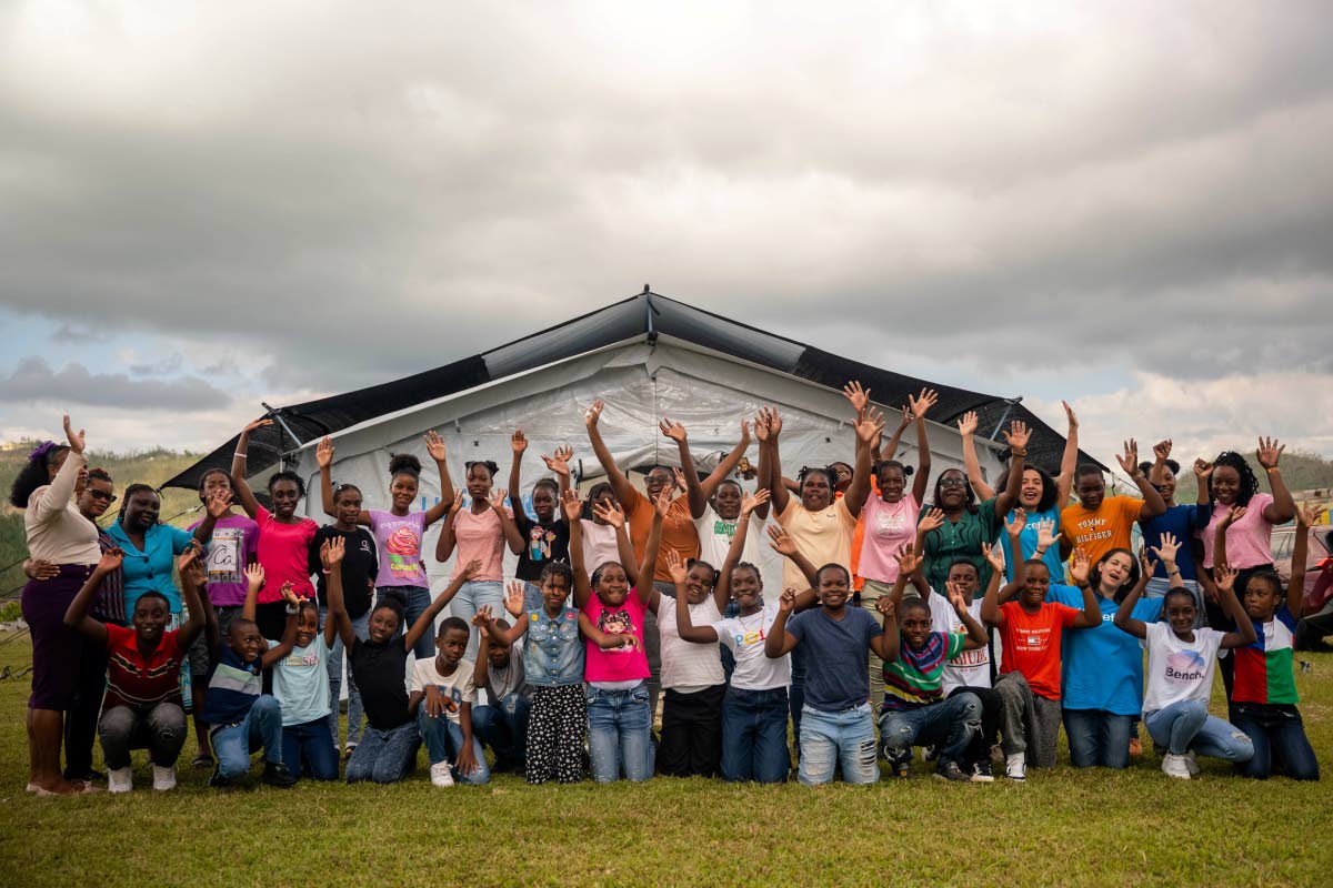 UNICEF Jamaica 
Children, facilitators, and community members gather outside a UNICEF-supported temporary learning space. 
