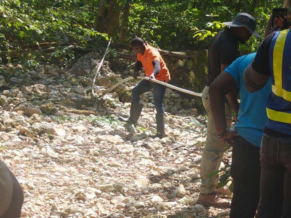 The National Water Commission personnel on an operation to remove illegal connections in Clarendon.