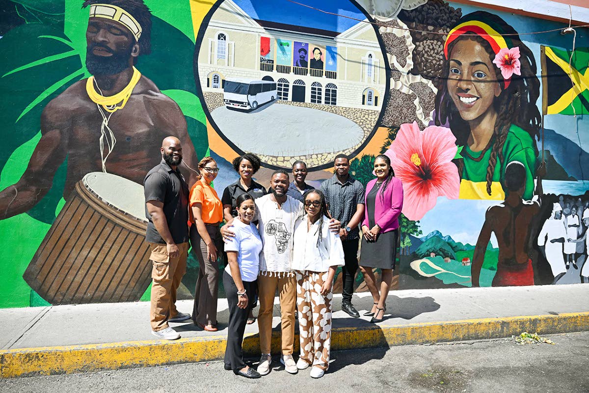 Front row, from left: Coral Williams, Target 8.9 Destinations Manager; Mayor of Montego Bay Richard Vernon; and Tova Hamilton, State Minister in the Ministry of Tourism, are joined by western artists and stakeholders in front of the mural “Deep Cultural 