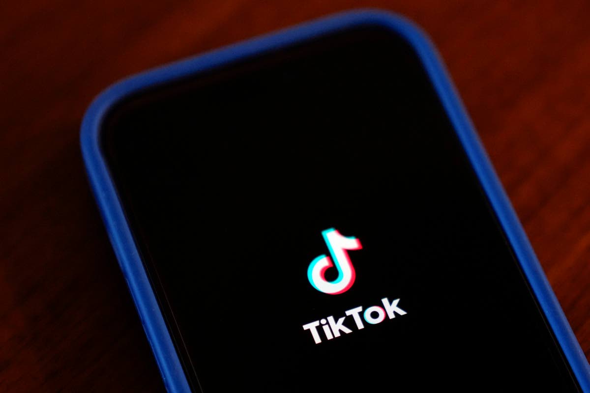 The TikTok app logo is shown on an iPhone.