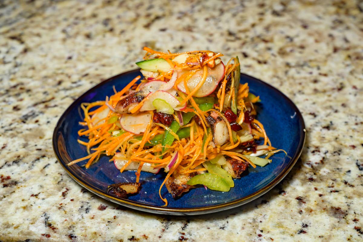 The octopus salad paired tender seared octopus with seasonal vegetables, craisins, and toasted almonds.