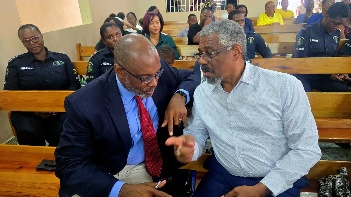 Dr Paul Hector (left) of UNESCO in conversation with Dr Patrick Prendergast, head of CARIMAC, during the More FM 14th anniversary church service, held on Sunday at the Duncans Evangelistic Centre in Trelawny.