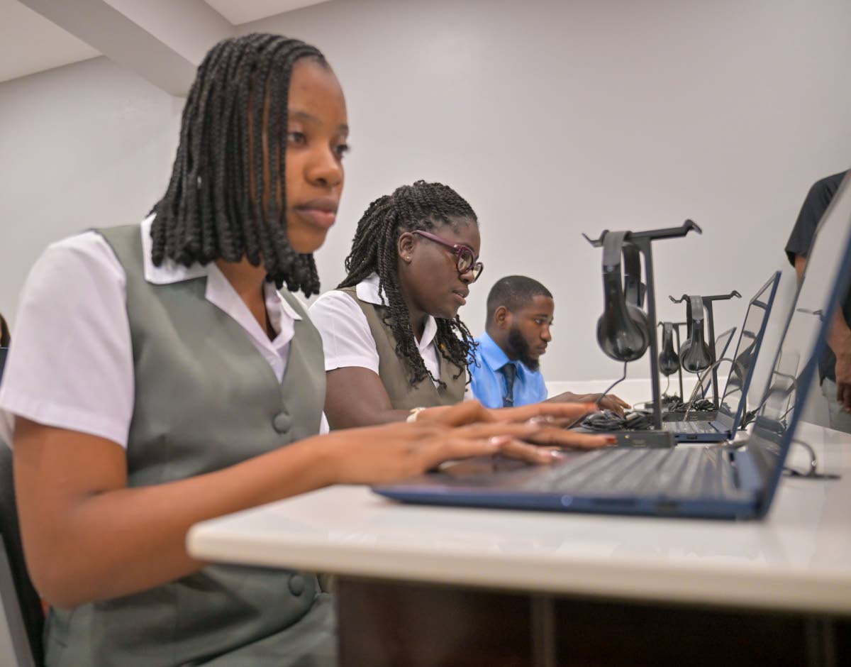 Students at Church Teachers’ College participate in an activity using laptop computers inside the Manchester-based institution’s newly opened smart lab. 