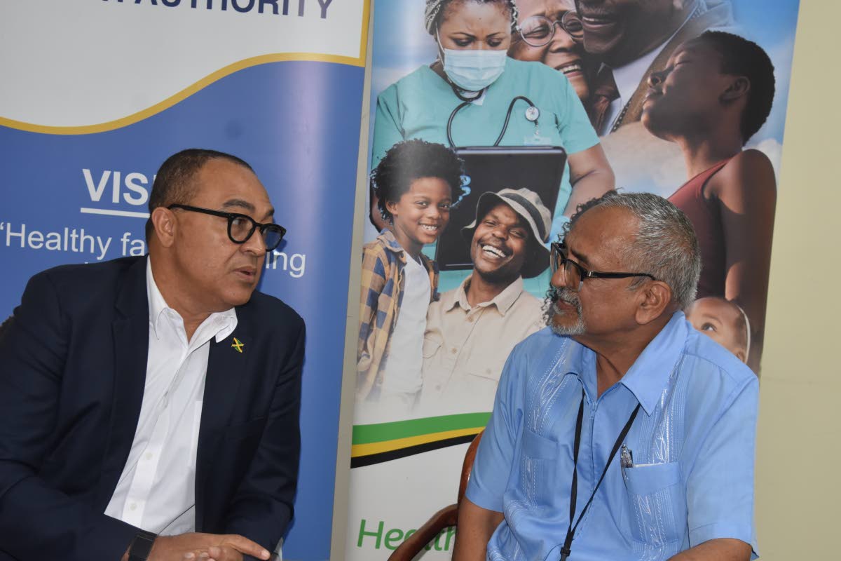 Health and Wellness Minister Dr Christopher Tufton (left) and Dr Delroy Fray, clinical coordinator, Western Regional Health Authority, converse during a press briefing at the WRHA’s offices in Montego Freeport on Thursday.