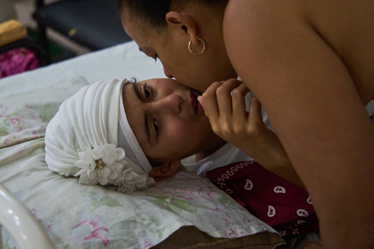 Niala Gonzalez, a cancer patient, is kissed by her mother at the National Institute of Oncology and Radiology in Havana, Cuba, Friday, February 20, 2026. 