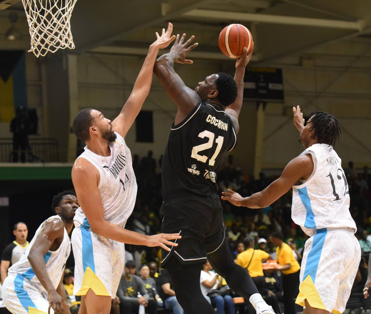 Jamaica Kofi Cockburn (centre) goes to the basket in the face of opposition from the Bahamas’ Isaiah Mobley (left) and Kenwan Smith during their FIBA World Cup Qualifiers at the National Indoor Sports Centre on Thursday.