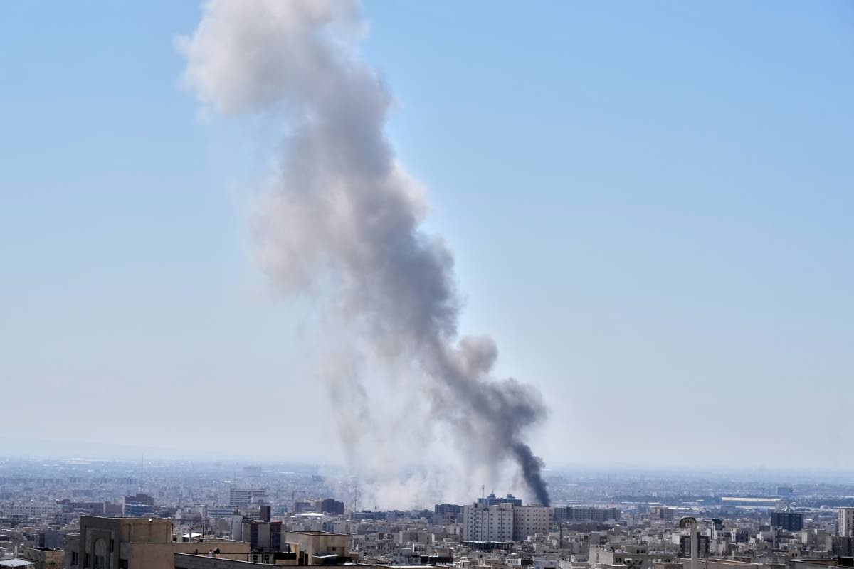 A plume of smoke rises after a strike in Tehran, Iran in March 1, 2026. (AP Photo/Vahid Salemi)