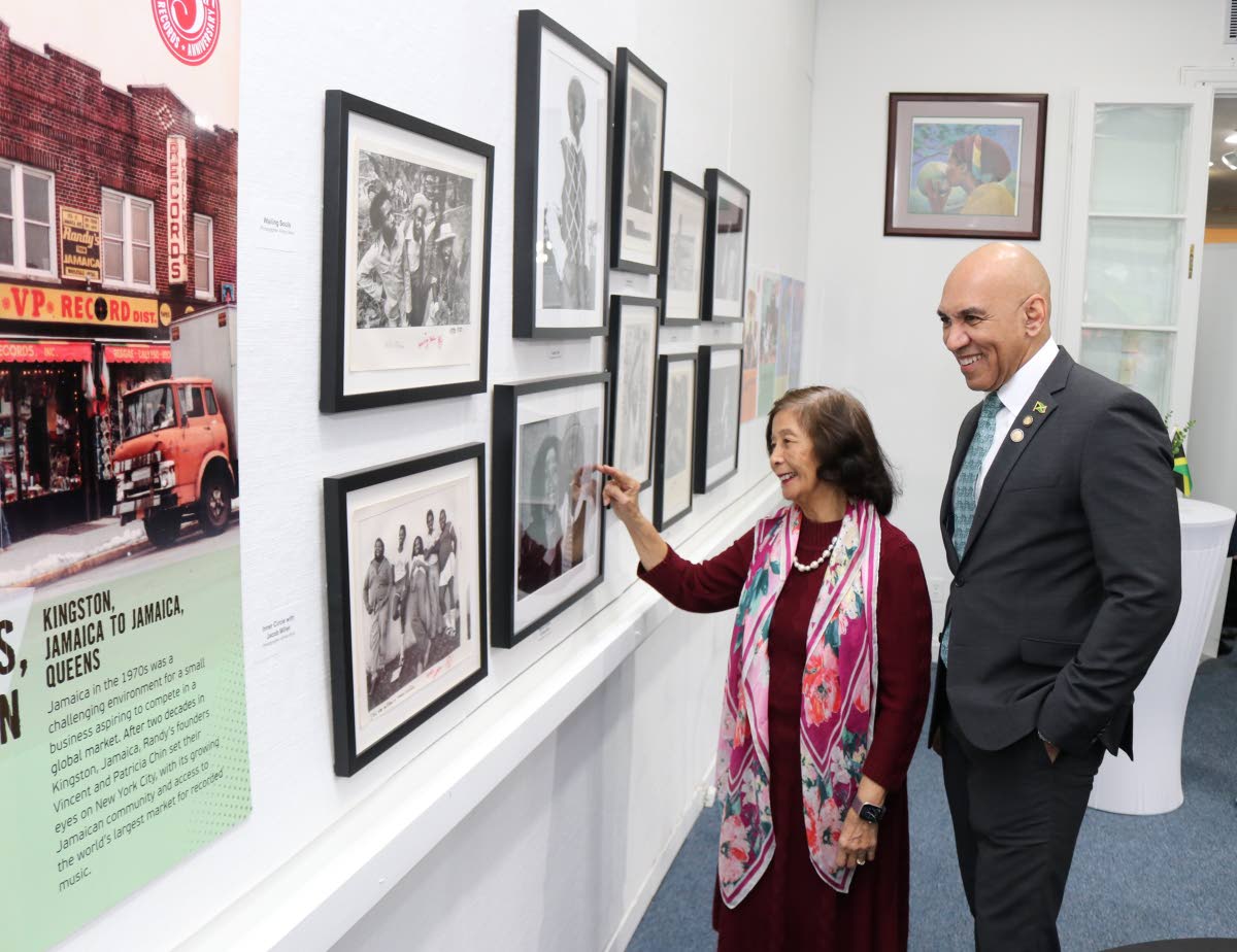 Patricia ‘Miss Pat’ Chin, co-founder of VP Records, explains to Jamaica’s Ambassador to the United States, Major General (Ret’d) Antony Anderson the concept of the pictorial exhibition titled ‘A Reggae Music Journey’, depicting the work of VP R