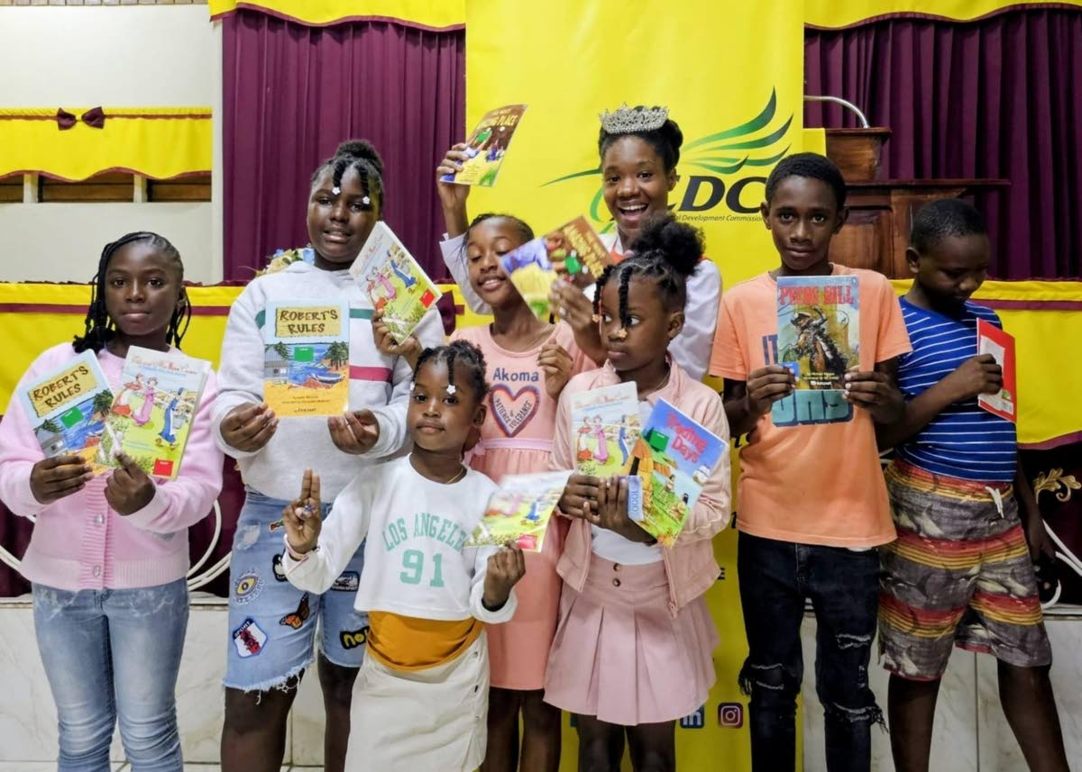 
St Ann Festival Queen 2025, Deveta Dowling, shares a moment with children who attended the launch of the ‘Ready to Read’ programme.