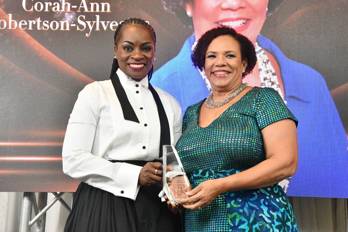 Robertson-Sylvester receives her award from Marisa Benain, founder of Plie for the Arts Jamaica.