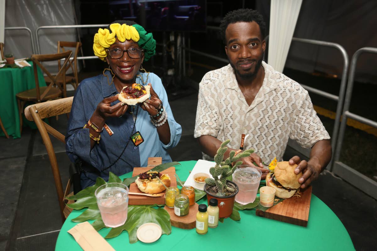 Jean Brown (left) and Imanuel Stennett from New York enjoy the beet and fetta burger with cho-cho fries from Stush in the Bush.