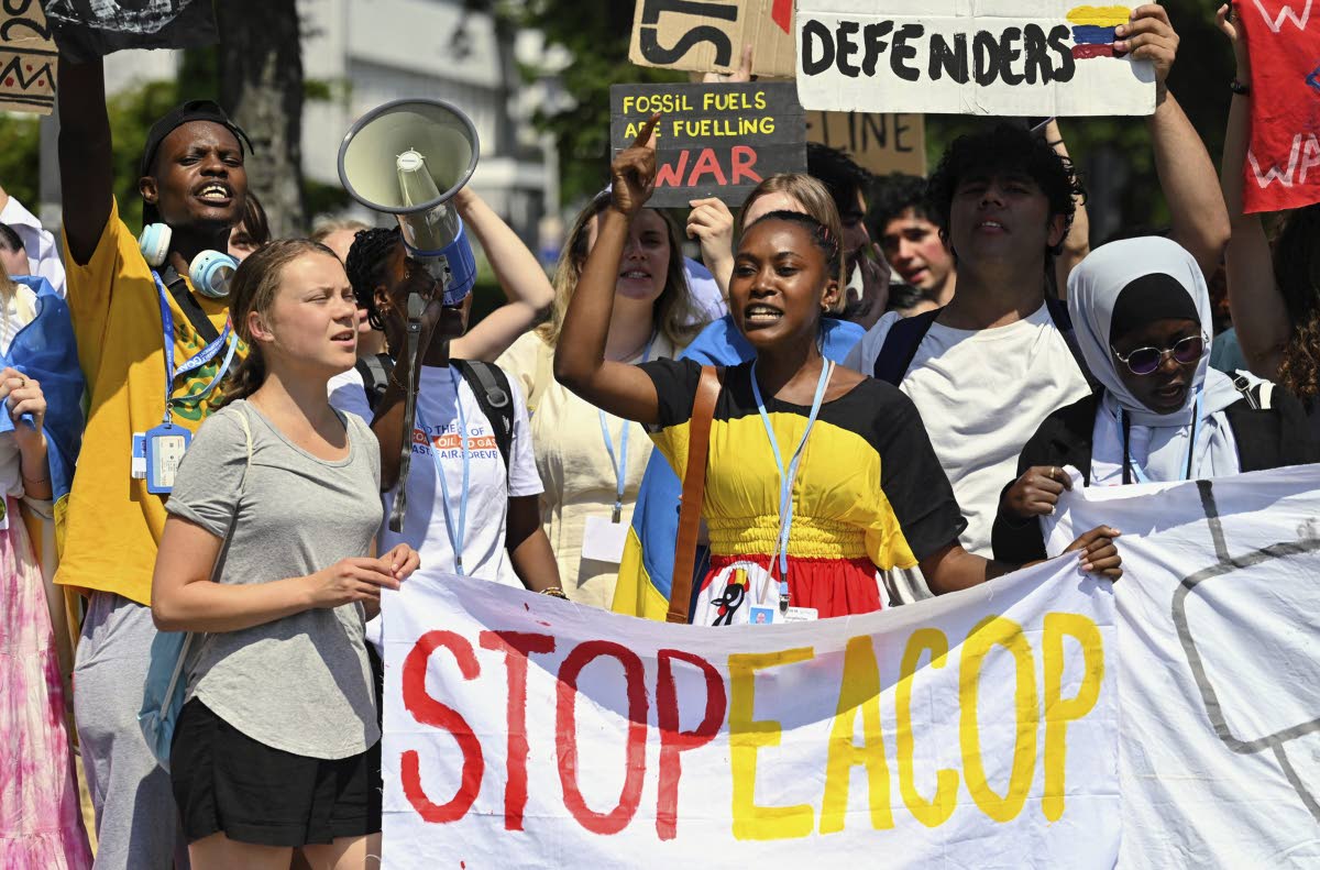 Patience Nabukalu, climate activist from Uganda (front centre) and Greta Thunberg (front left) attend a Fridays for Future protest rally in Bonn, Germany, Monday, June 12, 2023 against a planned oil pipeline in East Africa. The project, which has been crit