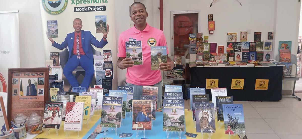 Everton G. Walker displaying his autobiographies.