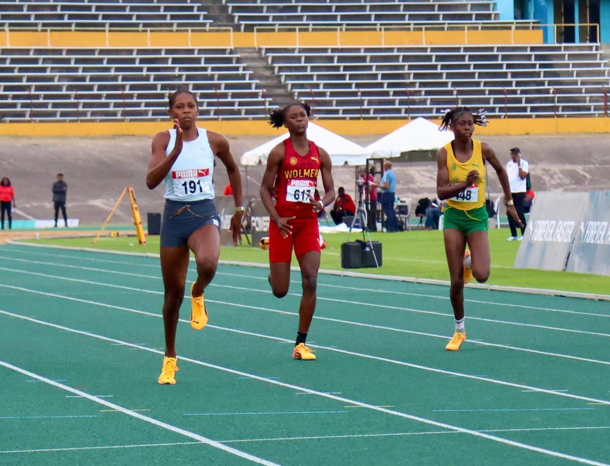 Holland High’s Shanoya Douglas (left) wins the girls’ Under-20 100m final in 11.06 seconds at the Carifta Trials at the National Stadium yesterday. Wolmer’s Girls’ Natrece East (centre) was second in 11.53 while Edwin Allen High’s Renecia Edwards