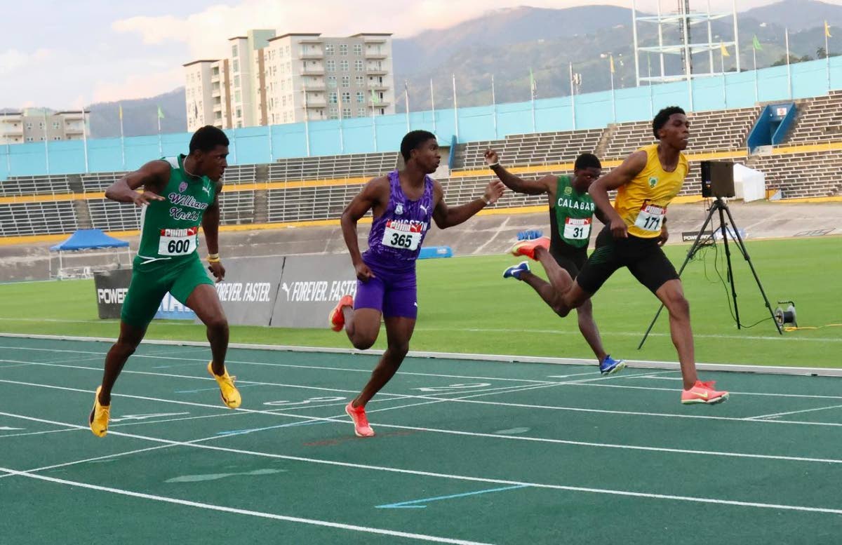 Excelsior’s Requelme Reid (right) wins the boys’ Under-20 100 metres final in 10.16 seconds at the Carifta Trials at the National Stadium yesterday. William Knibb Memorial High’s Sanjaye Seymour (left) was second in 10.20 while Kingston College’s N