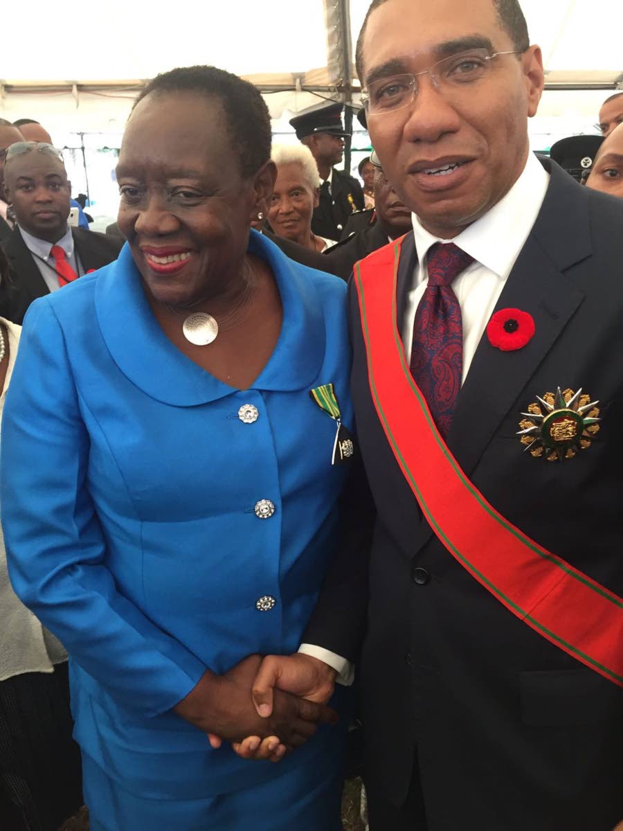 Dr Millicent Comrie (left) is congratulated by Prime Minister Andrew Holness shortly after she was presented with the insignia of the Order of Distinction at the National Awards Ceremony on the lawns of King’s House, St Andrew, in 2016.