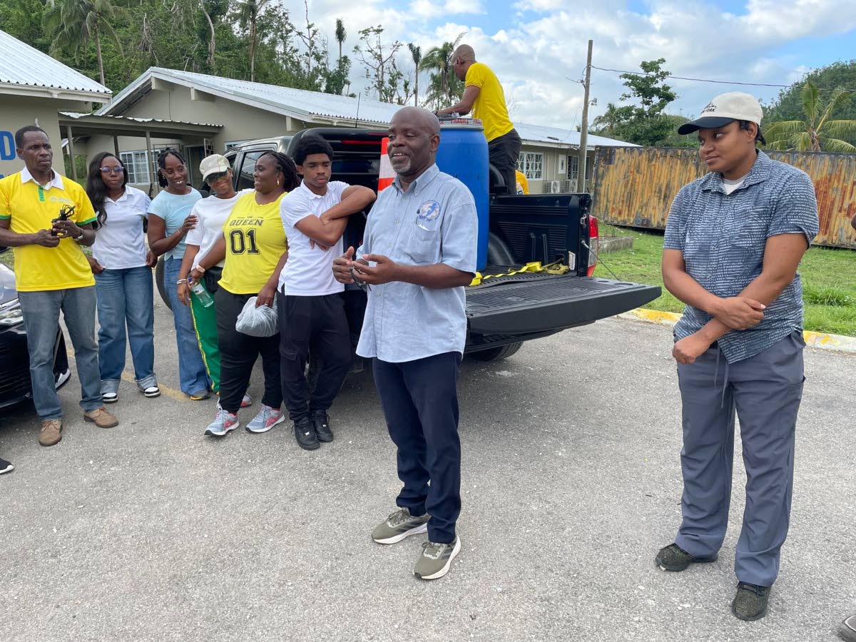 Wesley Boynes (centre), chairman of the Northgate Youth and Family Development Foundation, speaking to volunteers with the group’s Operation GRACE initiative outside the Cambridge Health Centre in Cambridge, St James, on March 7, following the official s