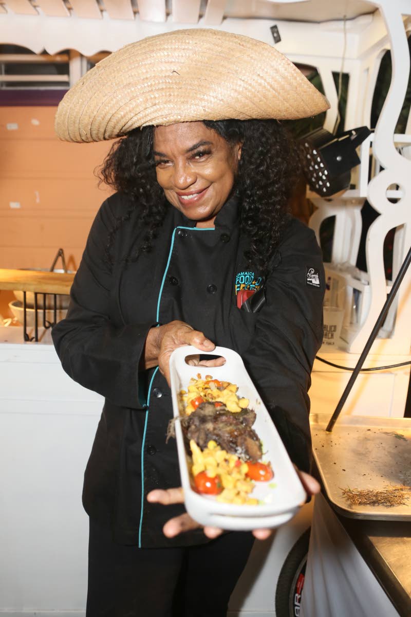 Chef Jacqui Tyson shows off her yard fire lamb, accompanied by charred corn and breadfruit succotash with roasted chickpeas.