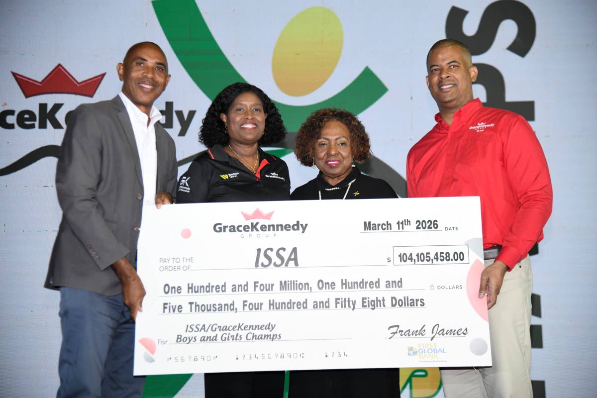 From left:  President of ISSA Keith Wellington; Margaret Campbell; chief executive officer, GraceKennedy Money Services; Olivia Grange, minister of sport; and CEO of GraceKennedy Group Frank James hold a cheque at the media launch of Champs 2026 at the Nat