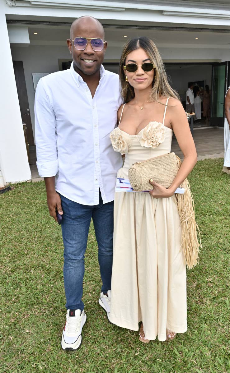 Ryan Reid, chairman of the First Rock Group of Companies, pairs up with Stephanie Harrison for a quick photo.