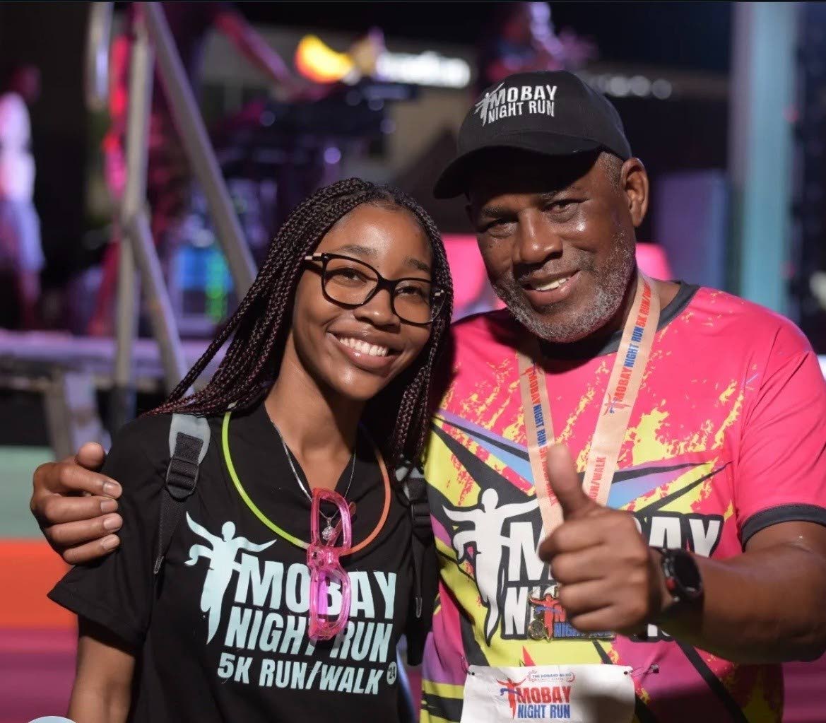 Jade Cohall-Cunningham shares a moment with Howard Ward, chairman of the Howard Ward Benefit Foundation, at the 2024 MoBay Night Run.