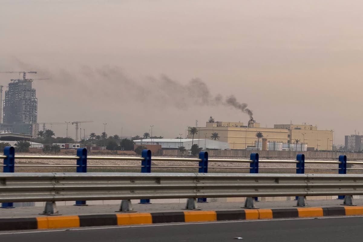 Smoke rises from the U.S. embassy building in Baghdad, Iraq on March 14, 2026. (AP Photo/Ali Jabar)