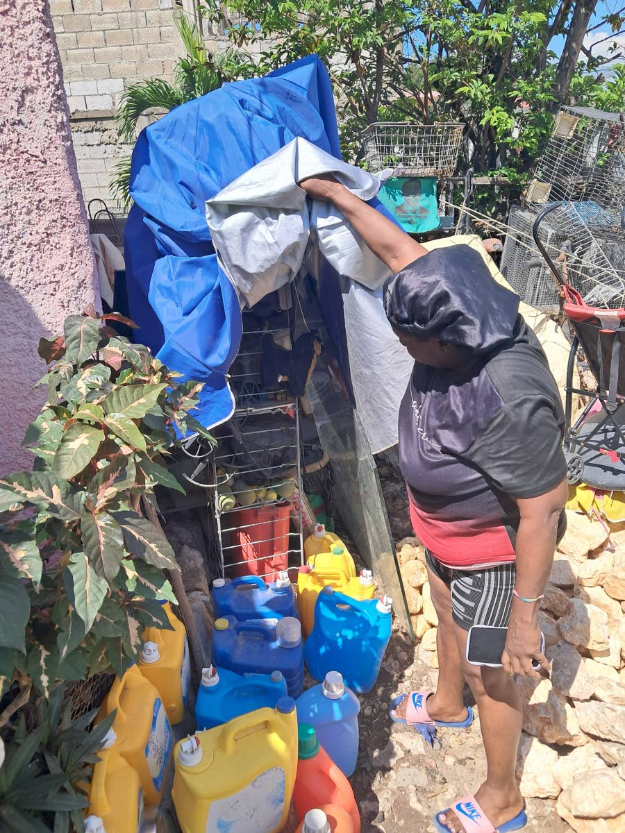 Sharon Burgess* examines some of the junk at the front of the yard where her brother stacks junk taken from off the streets.