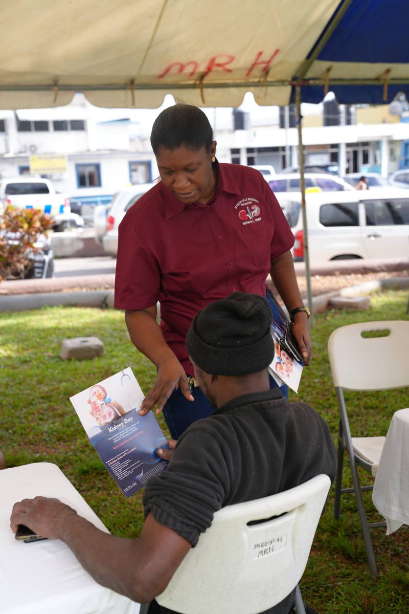 Marika Davis- Miller, nurse manager at the Mandeville Regional Hospital Renal Unit, provides guidance on kidney care to a participant at the health fair.