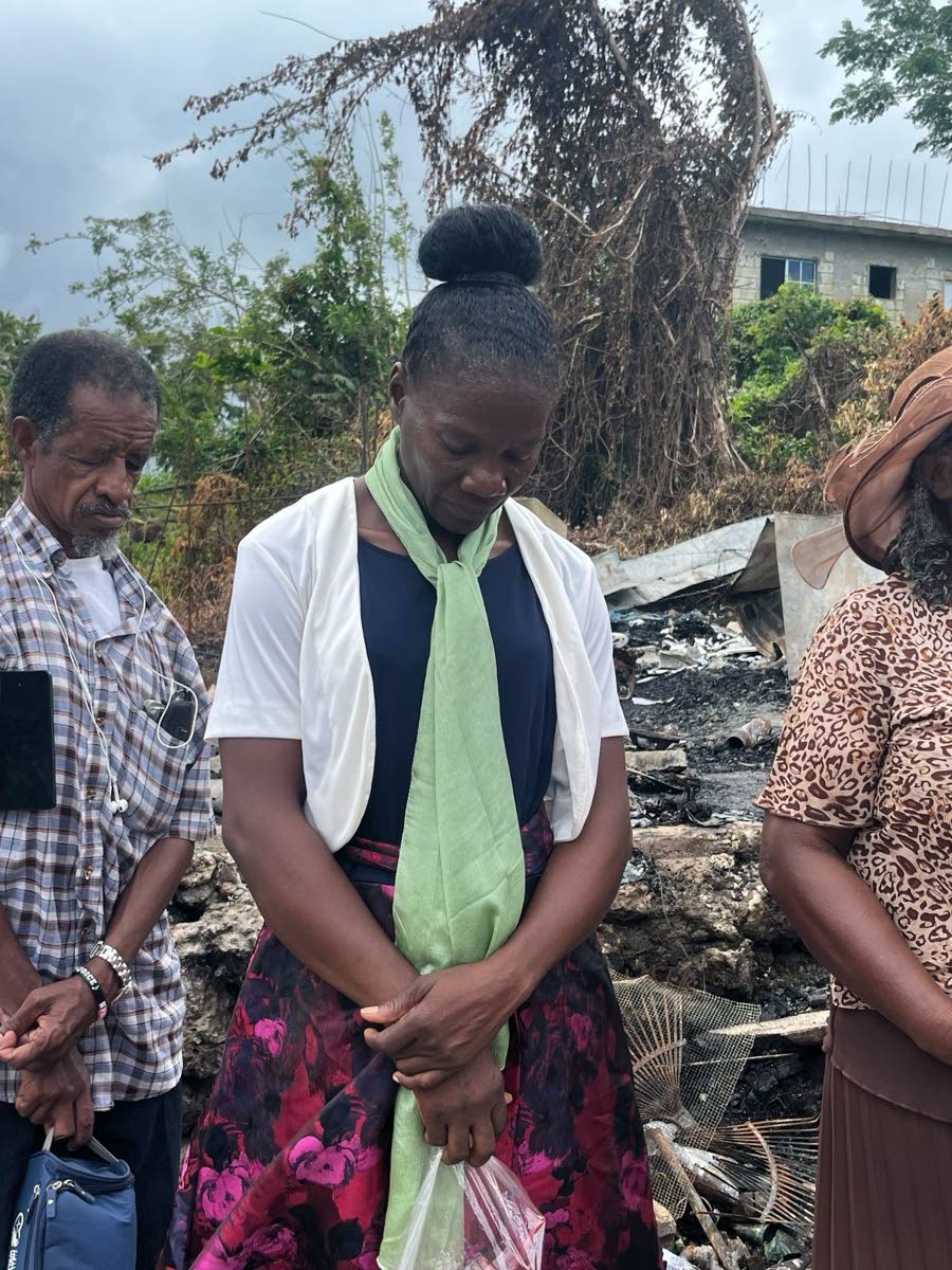 Natalie Watson with members of her church at the site of the fire.