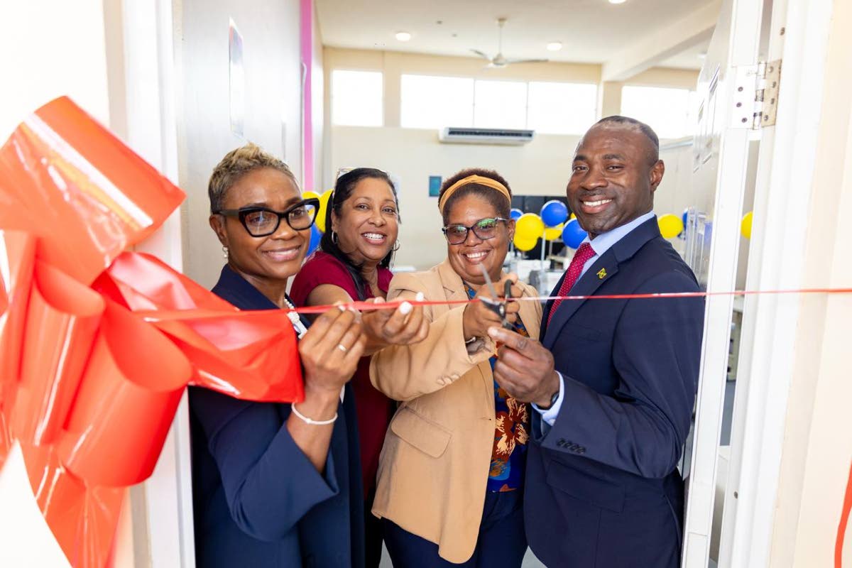 State Minister in the Ministry of National Security and Peace, Juliet Cuthbert-Flynn (left), joins in the cutting of ribbon to open a sewing lab at the South Camp Juvenile Correctional and Remand Centre in Kingston. Others (from left) are CEO, Digicel Foun