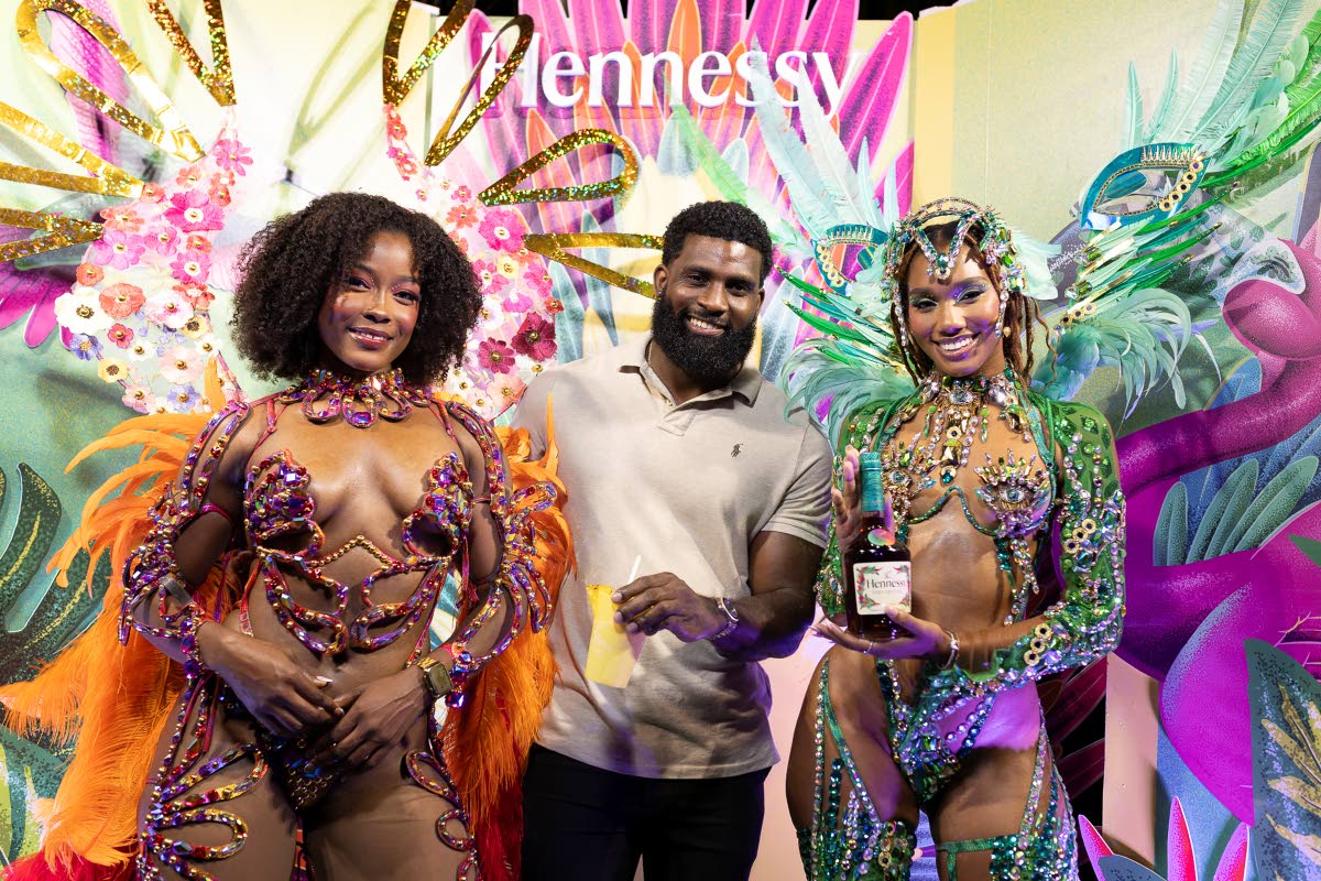 Content creator and model Andre Estafan is flanked by Yard Mas models Amina McKenzie (left) in Ebony and Chante-Marie Samlal in Picasso.