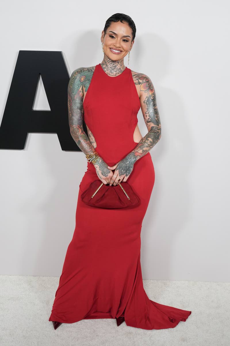 Khelani goes monocromatic, pairing a red Alexandre Vauthier cutout gown with a JW PEI Lila clutch.